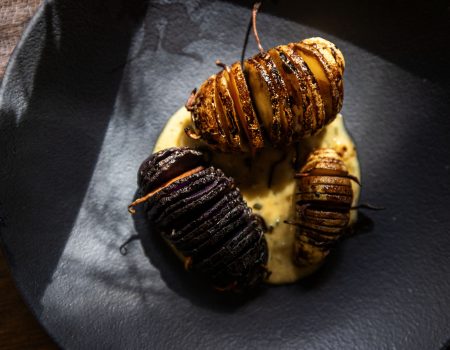 Cellar Dwellers: Hasselback Potato Bugs with Stilton–Chardonnay Butter Sauce